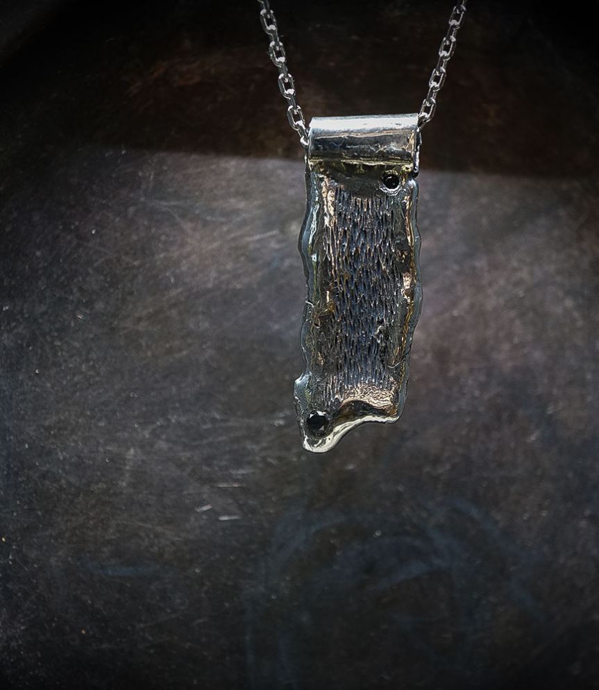 Collier en argent brut et diamant noir.